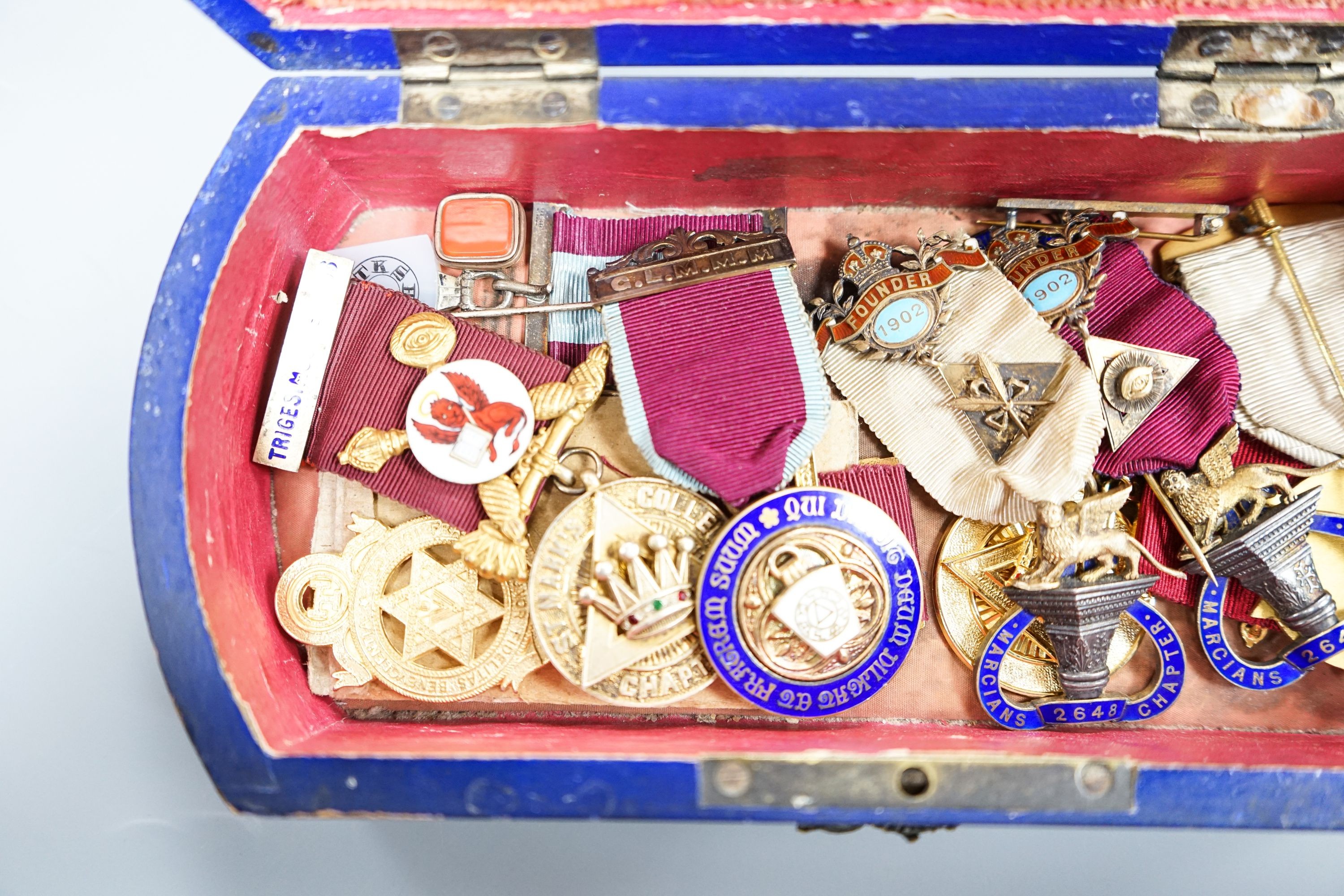 A group of Masonic medals some silver gilt, in a painted wood box